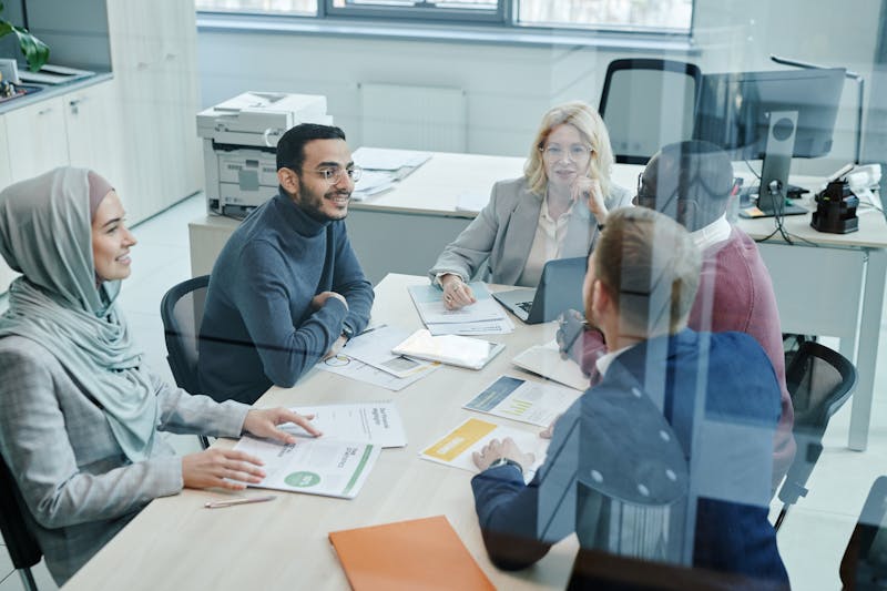 ACU team members collaborating in a modern financial services office